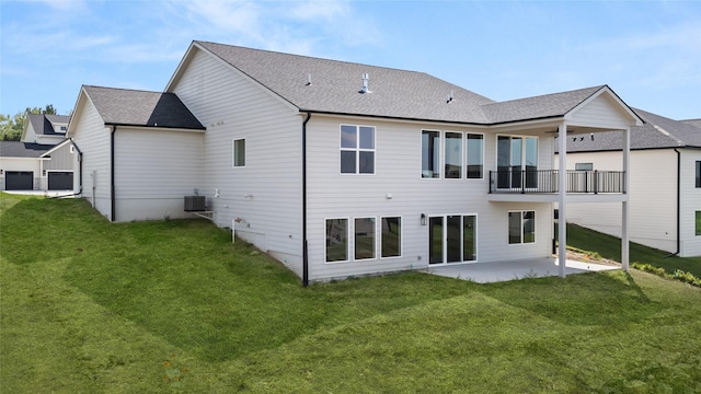 rear view of house with roof with shingles, a patio area, a yard, and central AC unit