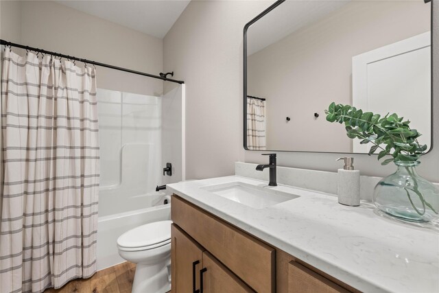 1185 NW 28th St, Grimes, IA 50111 - full bathroom with wood finished floors, vanity, toilet, and shower / tub combo