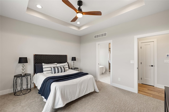 bedroom featuring baseboards, visible vents, a raised ceiling, and recessed lighting