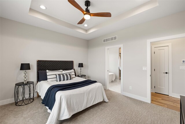 1185 NW 28th St, Grimes, IA 50111 - bedroom featuring a tray ceiling, recessed lighting, baseboards, and light carpet