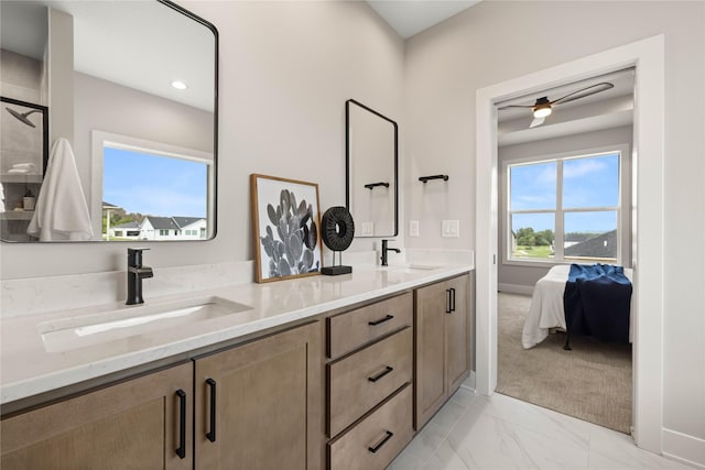 bathroom with double vanity, marble finish floor, a ceiling fan, and a sink