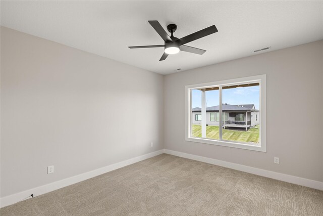 1185 NW 28th St, Grimes, IA 50111 - spare room with light colored carpet, baseboards, and ceiling fan