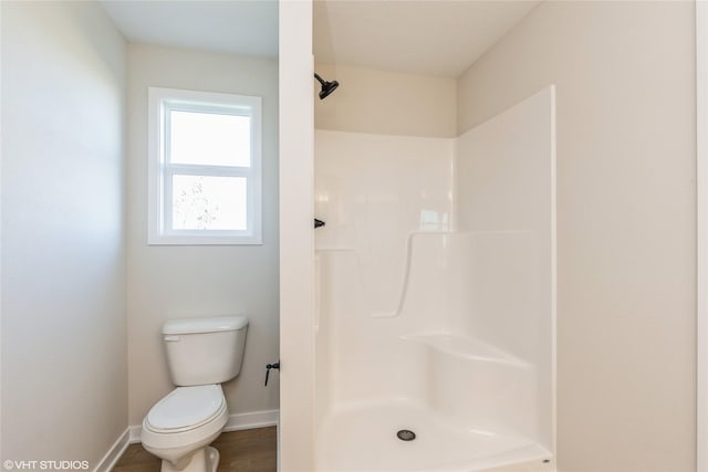 bathroom with toilet and a shower