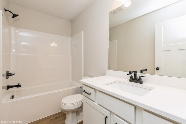 full bathroom featuring hardwood / wood-style flooring, vanity, toilet, and shower / bath combination