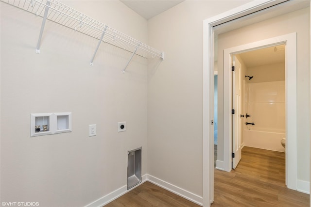 laundry area featuring hookup for an electric dryer, hardwood / wood-style floors, and washer hookup