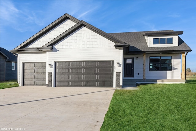 view of front of property featuring covered porch, a garage, and a front lawn