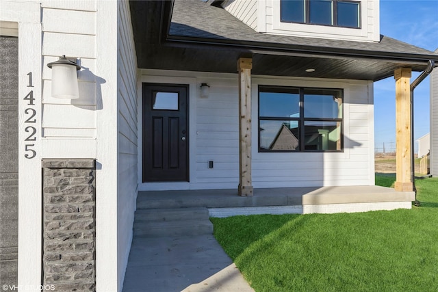 view of exterior entry with a porch