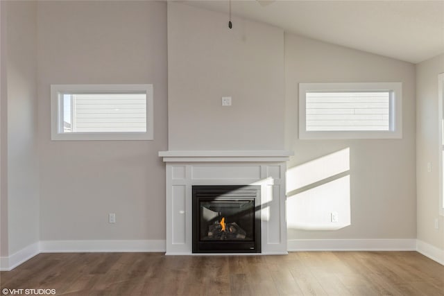 unfurnished living room featuring wood-type flooring and vaulted ceiling