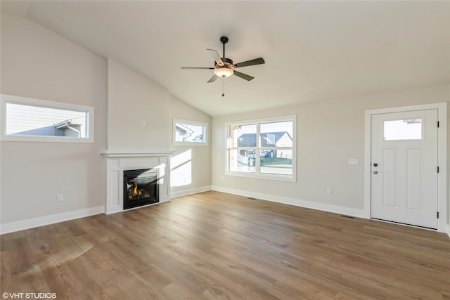 unfurnished living room featuring wood-type flooring, ceiling fan, and lofted ceiling