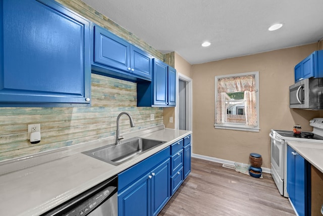 kitchen featuring light hardwood / wood-style flooring, tasteful backsplash, blue cabinets, sink, and stainless steel appliances