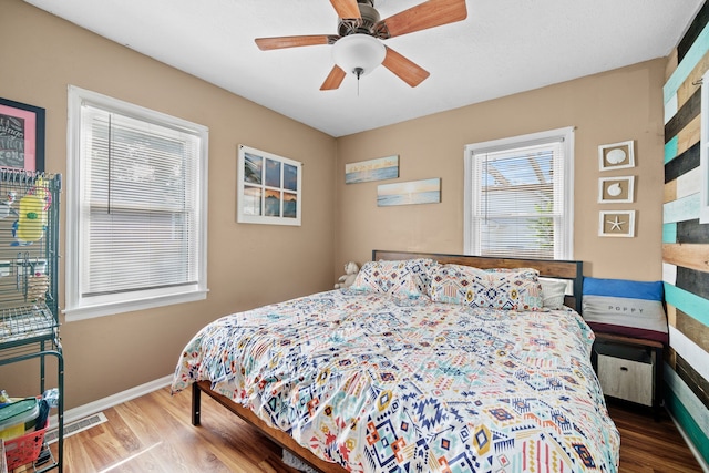 bedroom with ceiling fan and hardwood / wood-style floors