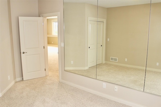 unfurnished bedroom featuring visible vents and baseboards