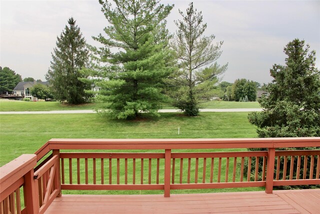 wooden deck with a lawn