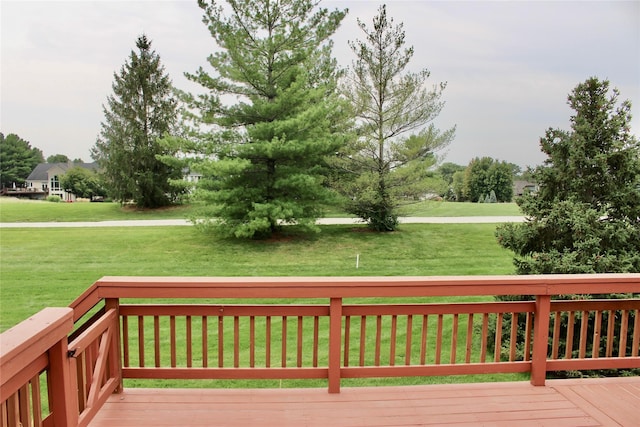 wooden terrace featuring a lawn