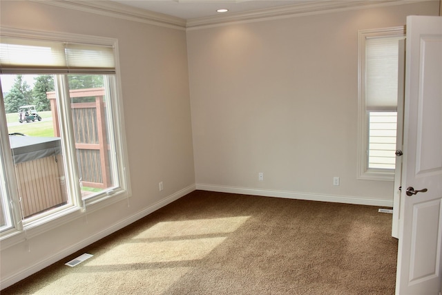 empty room featuring ornamental molding, carpet flooring, visible vents, and baseboards