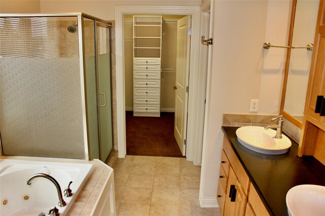 bathroom featuring tile patterned floors, independent shower and bath, and vanity