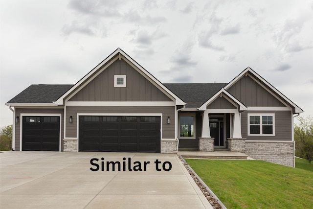 craftsman house with driveway, stone siding, board and batten siding, an attached garage, and a front yard