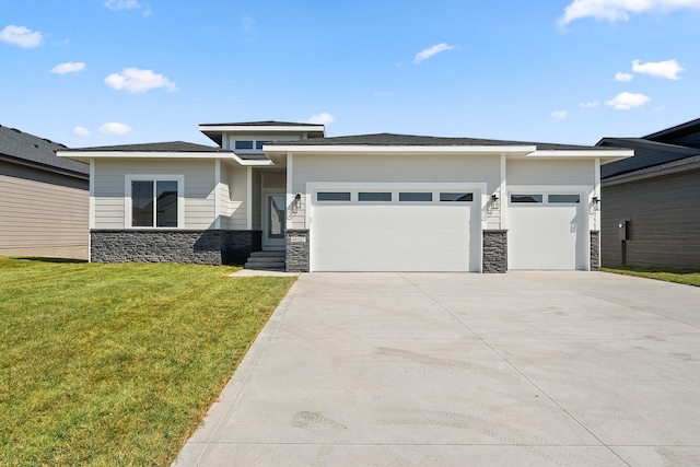 prairie-style home with a front yard and a garage