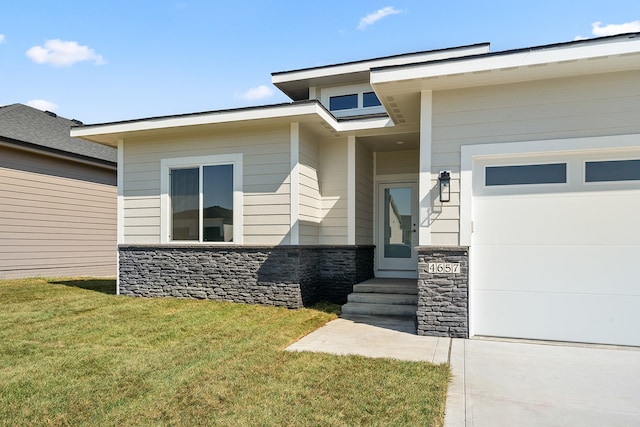 entrance to property with a lawn and a garage