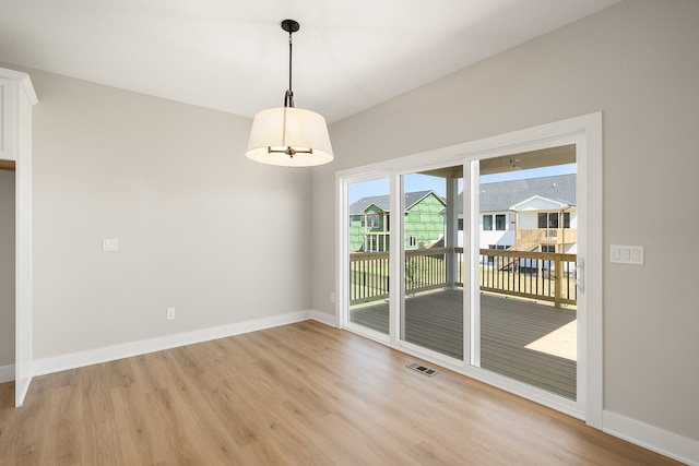 unfurnished dining area with light hardwood / wood-style flooring