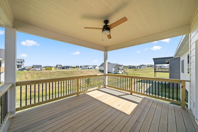 deck with a yard and ceiling fan