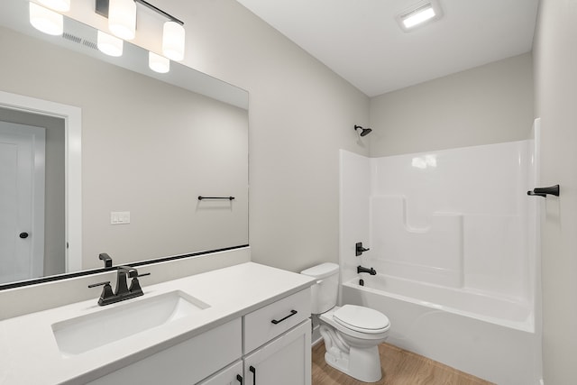 full bathroom with shower / tub combination, hardwood / wood-style floors, vanity, and toilet