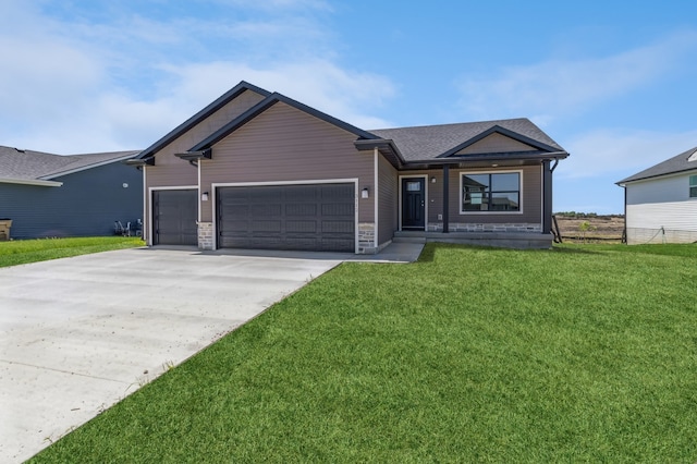 ranch-style house featuring a front yard and a garage