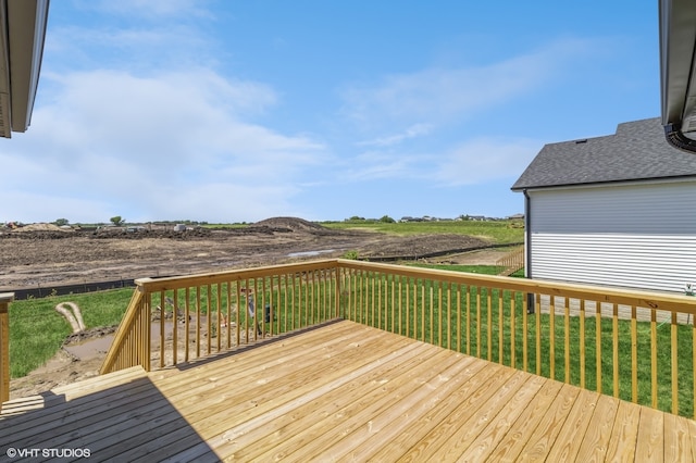 wooden deck featuring a lawn