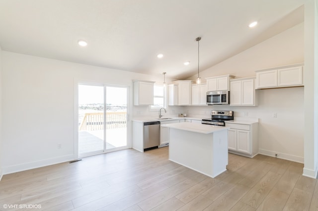 kitchen with a center island, white cabinetry, sink, and appliances with stainless steel finishes