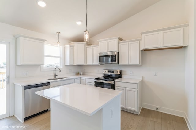 kitchen with appliances with stainless steel finishes, sink, and white cabinets