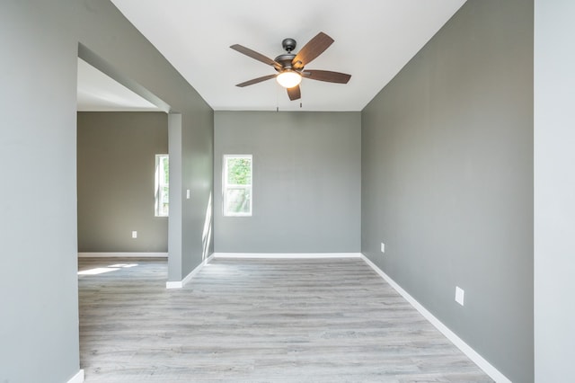 empty room with ceiling fan and light wood-type flooring