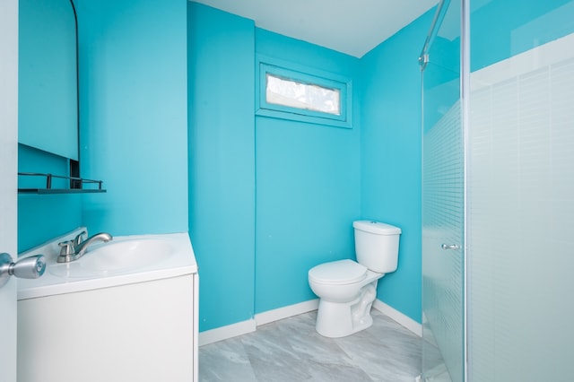 bathroom with walk in shower, vanity, and toilet