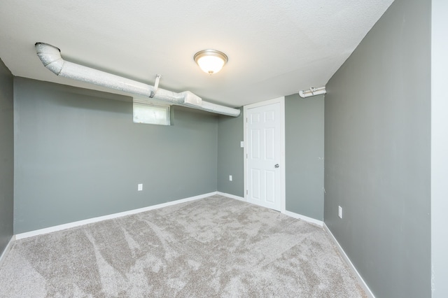 basement with carpet and a textured ceiling