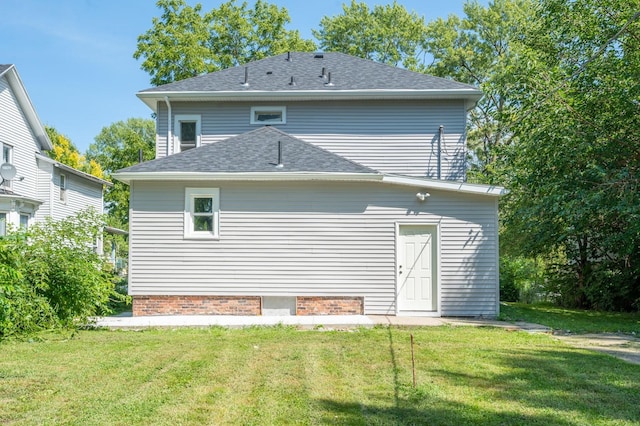 rear view of house with a yard