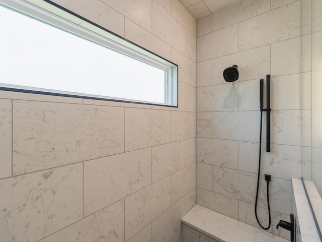 bathroom with a tile shower