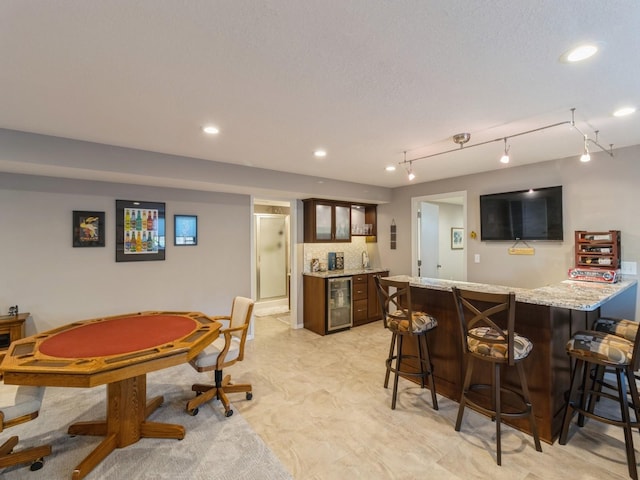 recreation room featuring beverage cooler and bar area