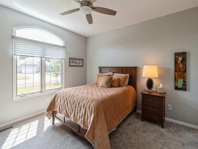 bedroom featuring dark colored carpet and ceiling fan