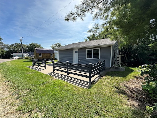 exterior space featuring an outbuilding and a front yard