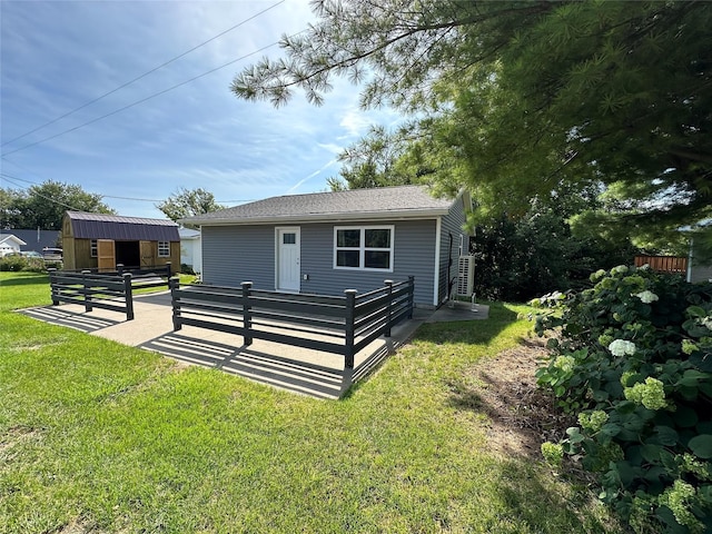 exterior space with a front yard and an outbuilding