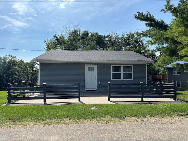 view of front of home with a patio and fence