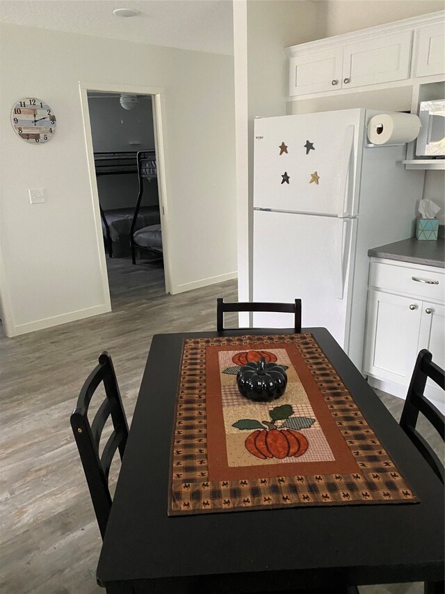 dining area featuring baseboards and wood finished floors