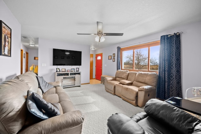 carpeted living room with a textured ceiling and ceiling fan