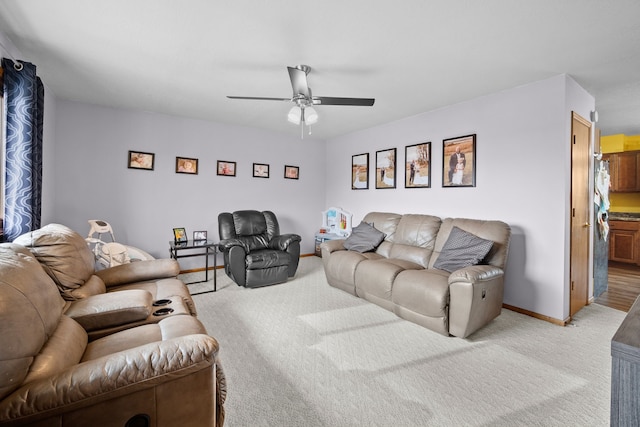 living room featuring light colored carpet and ceiling fan