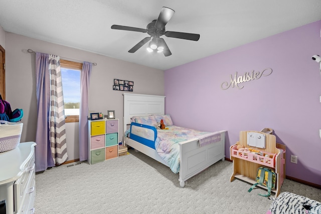 bedroom featuring ceiling fan and light carpet