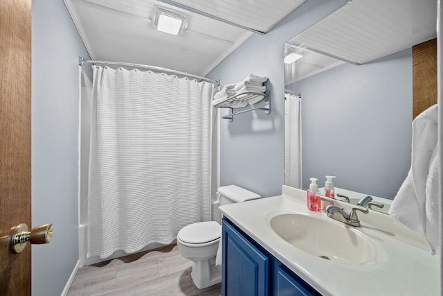 full bathroom with wood-type flooring, ornamental molding, toilet, and vanity