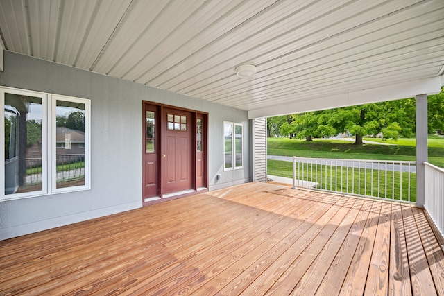 wooden terrace featuring a yard