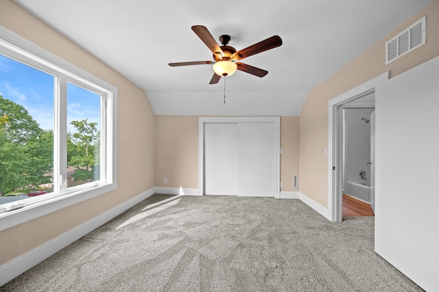 unfurnished bedroom featuring lofted ceiling, ceiling fan, and carpet flooring