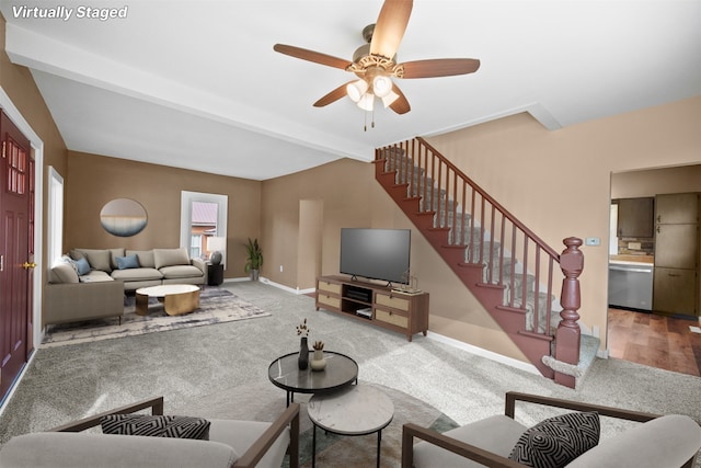 living room with ceiling fan, beam ceiling, and carpet flooring