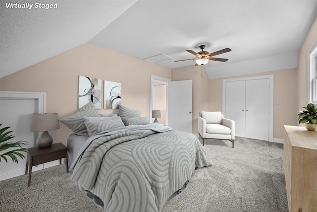 carpeted bedroom with vaulted ceiling, ceiling fan, and a textured ceiling