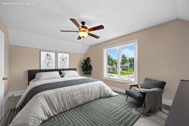 carpeted bedroom with ceiling fan and lofted ceiling